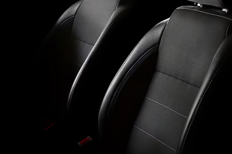 Close-up of black car seats with a dark background
